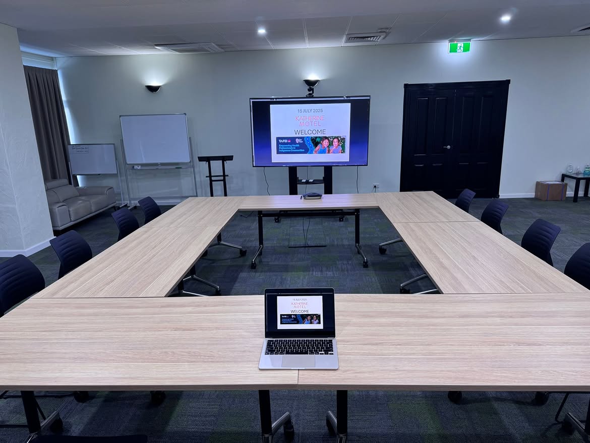 Katherine Motel conference room with U-shaped boardroom tables, large presentation TV, laptop and professional multimedia setup