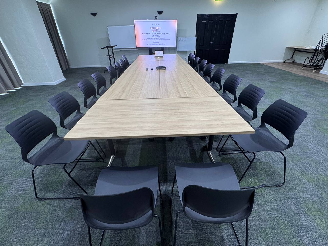 Long boardroom table arrangement with executive chairs for training sessions
